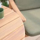 Close-up of round wooden bistro table top with slatted design and natural wood grain finish.