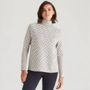 Front view of a woman wearing a long-sleeve high-neck top in a cream base with an all-over houndstooth-style pattern in black, olive and beige, paired with dark leggings.