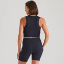 Back view of the model wearing the navy cropped sports top and fitted shorts, showing the streamlined fit and rear seam detailing.