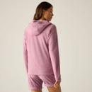 Back view of the model wearing the pink textured hooded jacket with matching shorts.