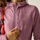 Close-up showing the pink jacket’s zip fastening, hood neckline and zipped chest pocket detail.