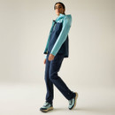 Side view of a model wearing navy walking trousers, styled with a two-tone hooded jacket and walking trousers.