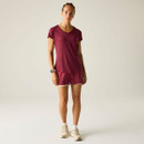 Full-length view of the model wearing the burgundy V-neck sports T-shirt and matching shorts with trainers.