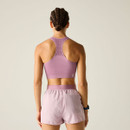 Rear view of model wearing mauve sports bra and lilac shorts, showing racerback.