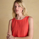 Close-up portrait of a woman modelling a sleeveless red linen top, showing the soft neckline and lightweight fabric.