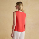 Back view of a sleeveless red linen top worn by a woman, highlighting the relaxed fit and curved hem.
