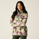 Model wearing Glacier Green Abstract Print half-zip fleece, arms folded, front view.