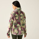 Rear view of model wearing Glacier Green Abstract Print half-zip fleece, showing back and high collar.