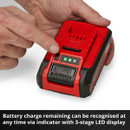A hand pressing a button on a red and black battery charger with a three-stage LED indicator. Text below reads, "Battery charge remaining can be recognised at any time via indicator with 3-stage LED display."