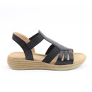 A side view of a strappy black sandal on a white background