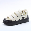 White strappy platform sandal with a gold buckle ankle strap and chunky black treaded sole on a white background.