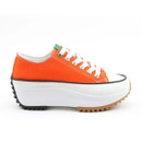 A side view of an orange platform trainer on a white background