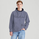 Front view of a man wearing a storm grey pullover hoodie with drawstrings and “Ridgeline” logo text across the chest. The hoodie features a large front kangaroo pocket with a vertical zip detail. He pairs it with light blue jeans against a plain light grey background.
