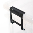 Close-up of a black clip handle on a clear storage box, highlighting the textured grip and locking mechanism.
