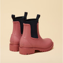Rear angle view of pink Chelsea-style rain boots featuring black elastic panels and pull loops.