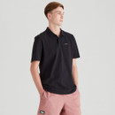 Side view of a man in a black Ridgeline polo shirt and pink shorts, showing the relaxed fit and short sleeves.