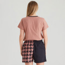 Back view of women's dusty rose Ridgeline T-shirt with contrasting two-tone black and rose houndstooth shorts.