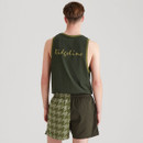 Rear view of a man wearing a dark green Ridgeline vest with gold script logo across the back, matched with two-tone green shorts featuring a half-houndstooth design, shown against a neutral backdrop.