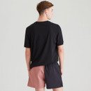 Rear view of a male model in a black T-shirt and Ridgeline black and rose two-tone shorts, showing the split-colour design and elasticated waist.