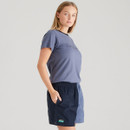 Side view of a woman in a blue Ridgeline T-shirt and two-tone navy shorts with side pockets and split-hem detailing.