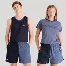 Two models wear matching color-block shorts split into dark navy and light blue halves, with an elastic waistband, side pocket, and small logo on the darker panel.