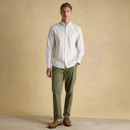 Close-up of chest pocket on men’s white multicoloured check Oxford shirt with embroidered blue hare logo.