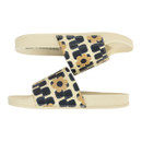 Side view of cream slide sandals showing flat sole and patterned upper.