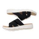 Pair of black crossover slide sandals shown in side profile.