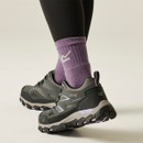 Grey walking shoes with reflective-style detailing, purple accents and chunky outdoor tread soles, worn with purple socks and black leggings.