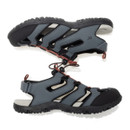 Pair of dark grey outdoor sandals shown in side profile.