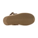 Underside of a tan suede clog showing the tan rubber outsole with a wavy tread pattern.
