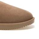 Close-up of a tan suede clog toe showing the soft textured upper, stitched edge and ridged tan outsole.