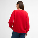 Back view of model wearing the red crew-neck sweatshirt with dropped shoulders.