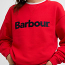 Close-up of the red sweatshirt showing the raised navy Barbour logo on the chest.