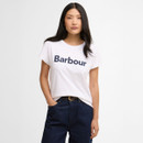 Model wearing a white Barbour logo T-shirt with navy lettering, styled with dark denim jeans.