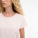 Close-up of the pale pink Barbour T-shirt showing the tonal “Barbour” logo on the chest and round neckline.