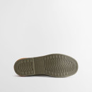 Outsole view of cream Barbour Chelsea wellington boot displaying durable rubber tread pattern and Barbour branding.