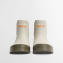 Front view of cream Barbour Chelsea wellington boots with rounded toe and raised Barbour logo badge.