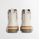 Rear view of cream Barbour Chelsea wellington boots with pull tabs and orange Barbour-branded heel accent.