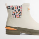 Cream Barbour ankle wellington boot with leopard print elastic side panels, textured rubber upper, contrast orange heel detail and low stacked sole on a white background.