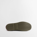 Outsole view of olive green Barbour Chelsea wellington boot displaying textured rubber sole with wave tread pattern for grip.