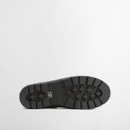 Outsole view of a cream Barbour Chelsea boot with heavy-duty tread pattern for grip.