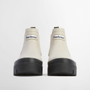 Front view of cream Barbour Chelsea boots featuring a raised platform sole and branded logo patch.