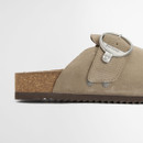 Side view of a taupe suede clog sandal with ribbed rubber outsole and natural cork midsole.