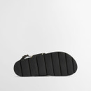 Underside view of black Barbour sandals showing textured rubber outsole with grip pattern.