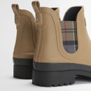 Rear three-quarter view of tan Barbour Chelsea boots highlighting pull tabs, tartan panels and deep tread soles.