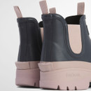 Rear view of Barbour navy Chelsea wellington boots highlighting blush pink heels, pull tabs and sturdy lug soles.
