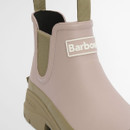 Detailed front-side view of a Barbour blush pink ankle wellington boot with raised logo badge and textured khaki sole.