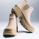 Barbour blush pink ankle wellington boots photographed with water droplets, highlighting waterproof finish and chunky khaki sole.