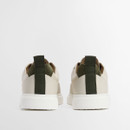 Back view of Barbour trainers showing structured heel, green pull tab and textured white outsole.